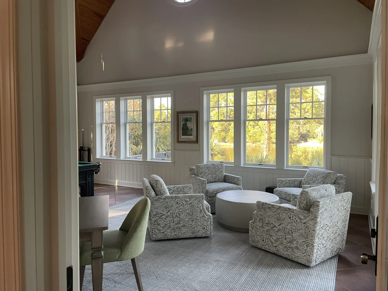 Sitting area with pale blue seating and garden views