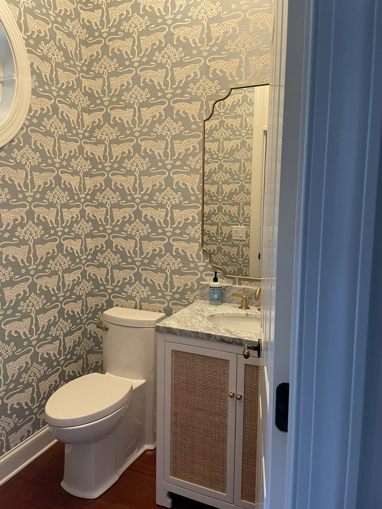 Powder room with patterned wallpaper