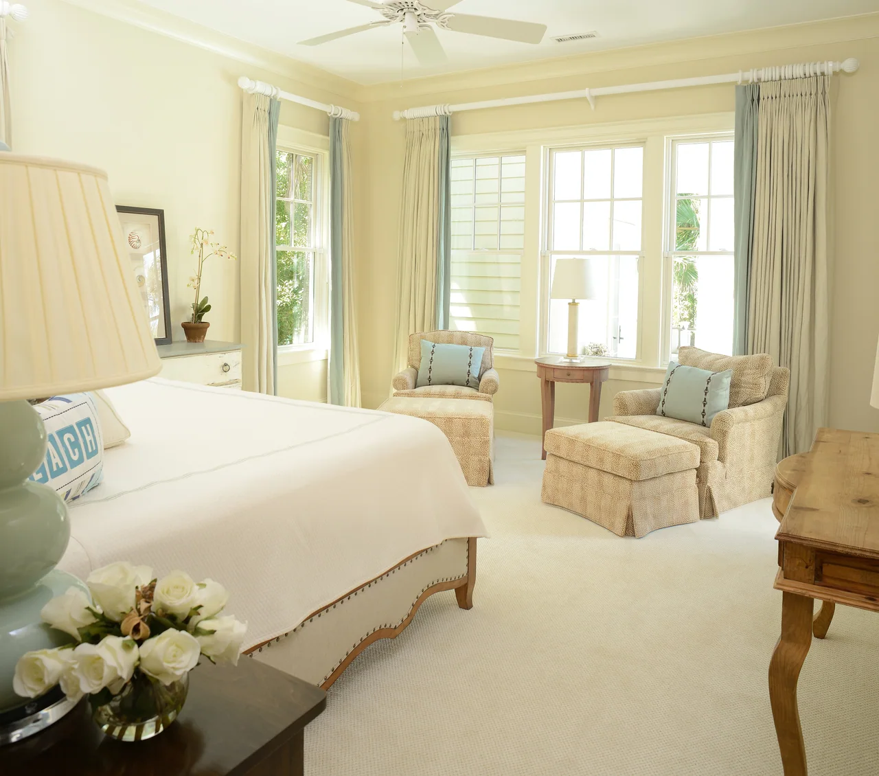 Bedroom with a soft upholstered headboard and window seating