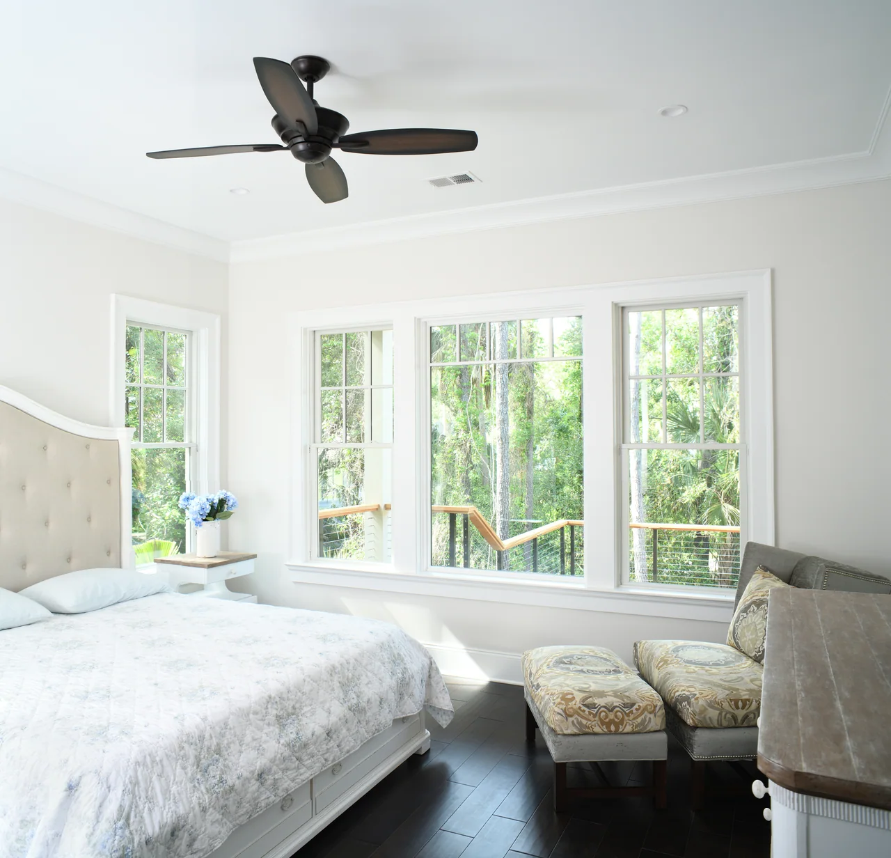 Bedroom with wide windows and woodland views