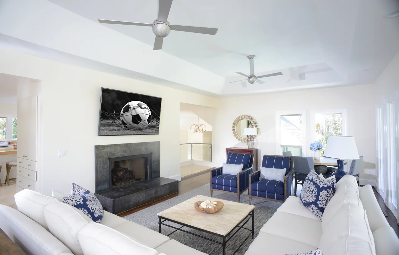 Living room with blue and white textiles and a fireplace