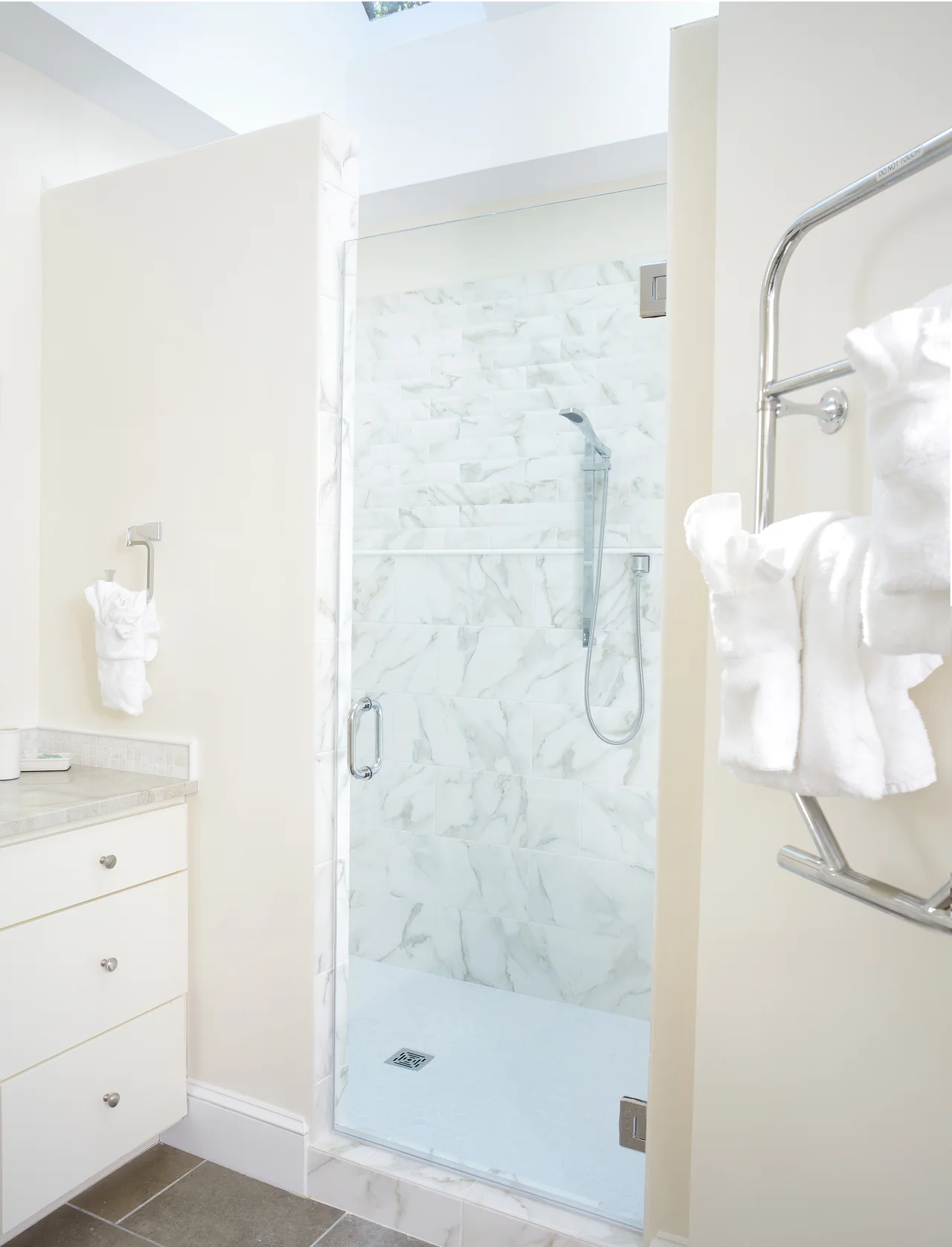 Bathroom with a glass shower and light stone finishes