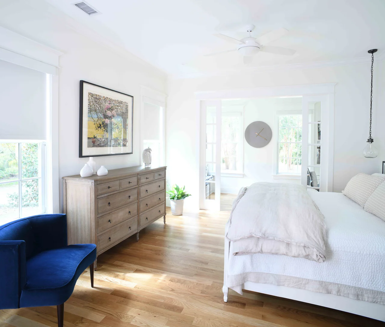 Bedroom with an upholstered headboard and deep blue chair